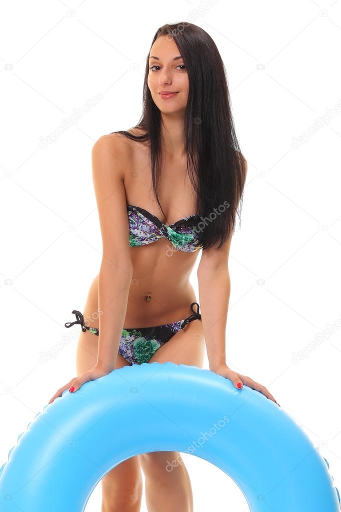 female in bikini holding swimming ring