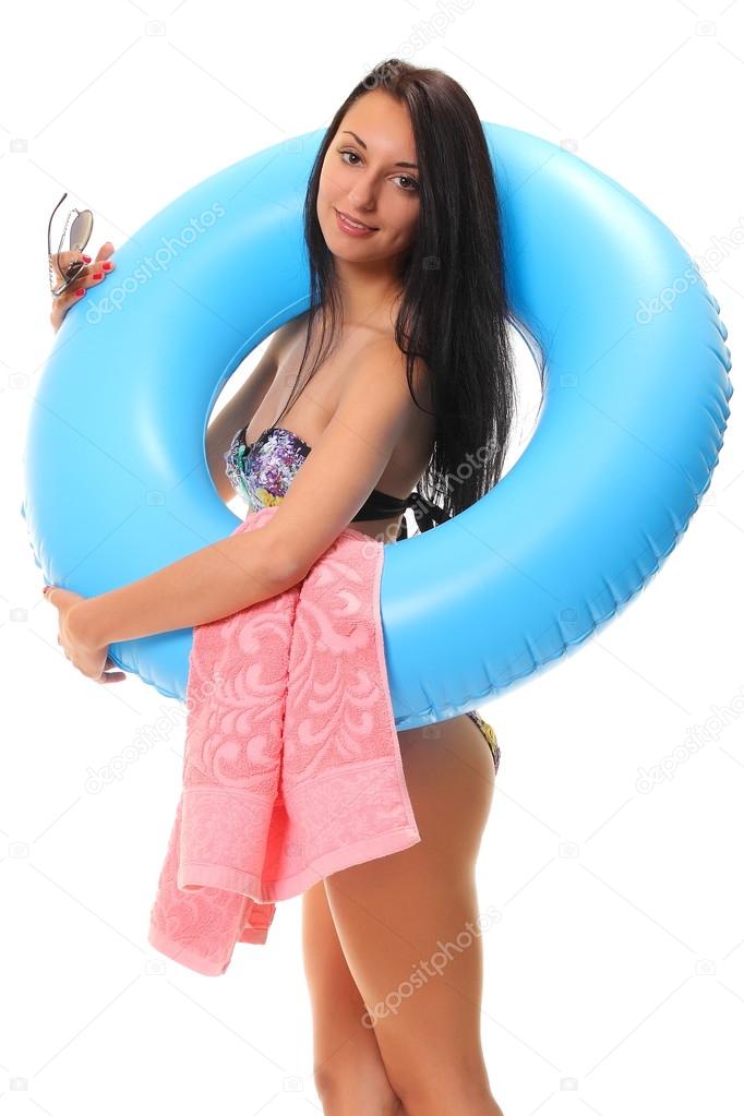 female in bikini holding swimming ring