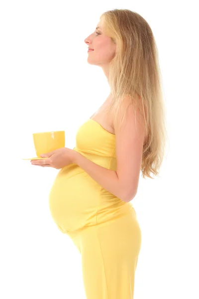 Hermosa mujer embarazada sosteniendo una taza — Foto de Stock