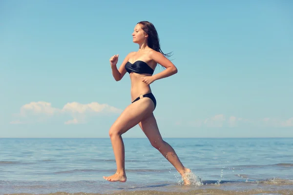 Woman running in the water — Stock Photo, Image