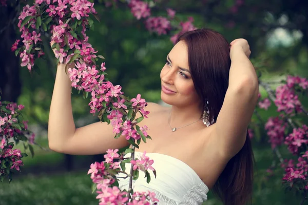 Flicka i blommor av äppelträd — Stockfoto