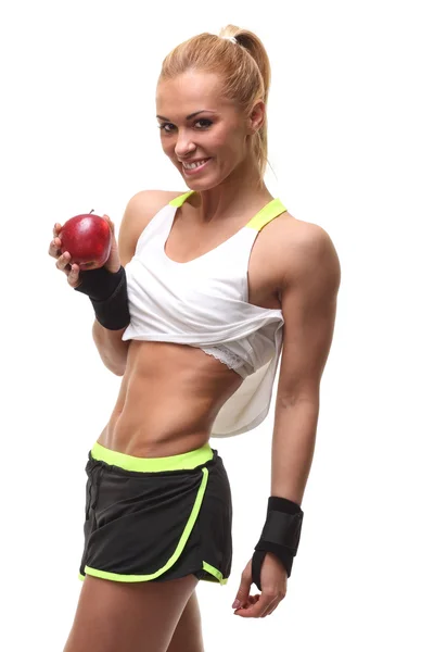 Junge Fitness-Frau glücklich lächelnd mit Apfel in der Hand — Stockfoto