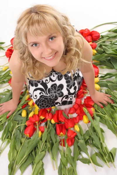 Beautiful girl in the tulips — Stock Photo, Image