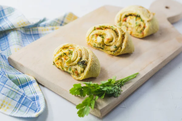 Home made buns with garlic, green parsley and sweet pepper in a napkin and wooden cutting board white background. — Stock Image Home Made Buns Garlic Green Parsley Sweet Pepper Napkin Wooden Stock Image