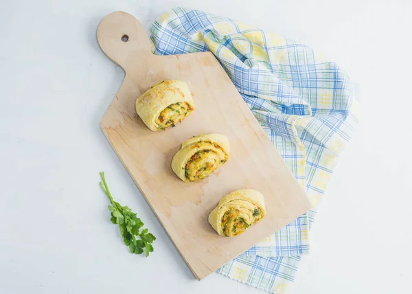 Home made buns with garlic, green parsley and sweet pepper in a napkin and wooden cutting board white background. — Stock Image Home Made Buns Garlic Green Parsley Sweet Pepper Napkin Wooden Royalty Free Stock Images