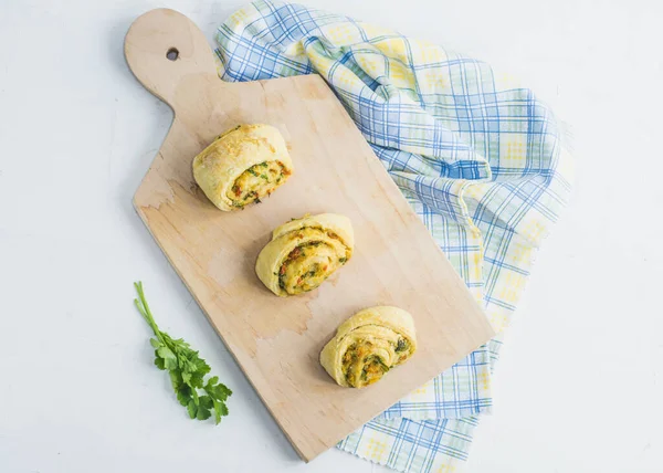 Home made buns with garlic, green parsley and sweet pepper in a napkin and wooden cutting board white background. — Stock Image Home Made Buns Garlic Green Parsley Sweet Pepper Napkin Wooden Stock Image