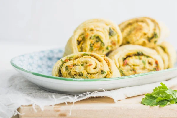 Home made buns with garlic, green parsley and sweet pepper in a plate with napkin and wooden cutting board white background. — Stock Image Home Made Buns Garlic Green Parsley Sweet Pepper Plate Napkin Stock Image
