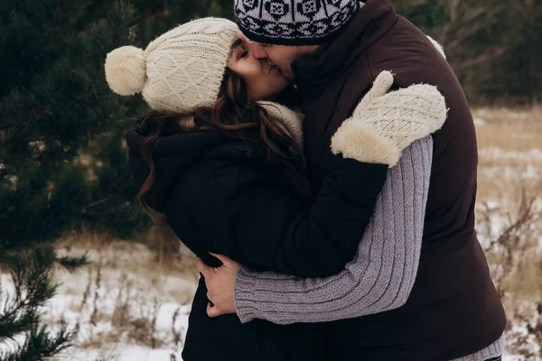Genç adam ve kadın ormanda öpüşürler. Kadın kocasına sıkıca sarıldı..