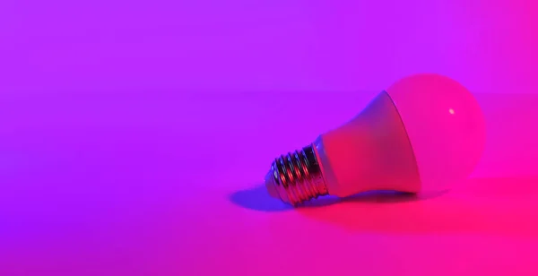 lamp in blue pink color neon background, empty space, ultraviolet light, photo taken in a photo studio