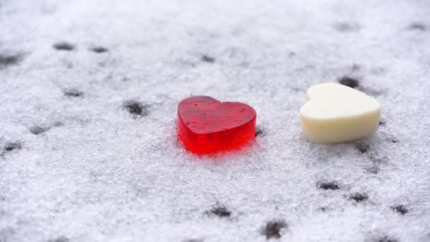 Valentine's Day concept, two hearts in the snow, copy space, close-up — Stock Video