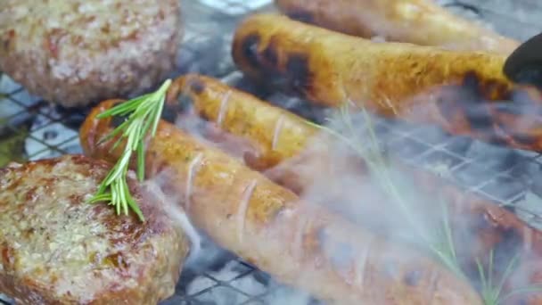 Grillkotletter och korvar med rosmarin stekt på kol, rått kött på grillen — Stockvideo