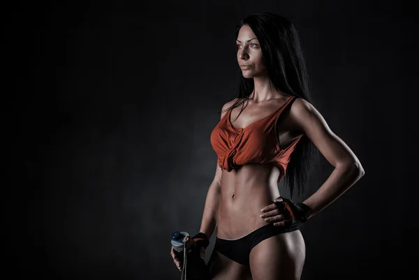 Brutal athletic woman pumping up muscles with dumbbells — Stock Photo, Image