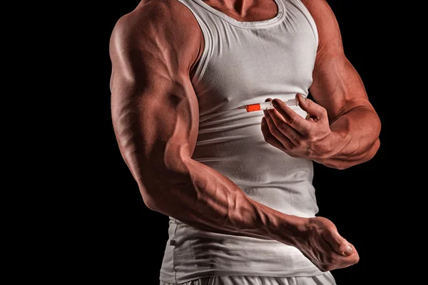 Un uomo muscoloso con una siringa Fotografia Stock