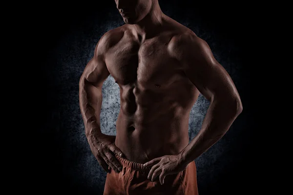 Strong athletic man on black background — Stock Photo, Image