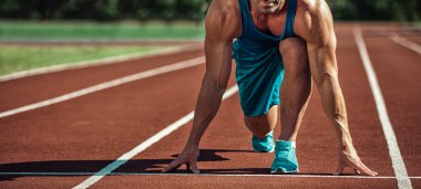 young muscular athlete is at the start of the treadmill clipart