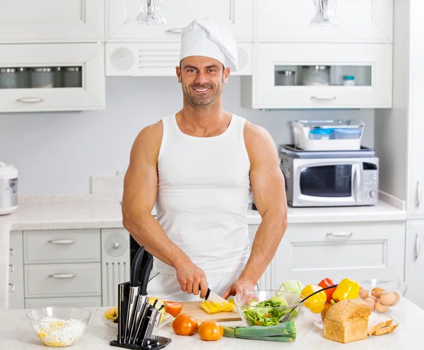 Feliz hombre guapo cocinando en la cocina en casa. —  Fotos de Stock