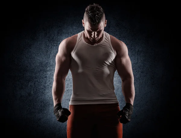 Handsome young man after a workout on a dark background — Stock Photo, Image