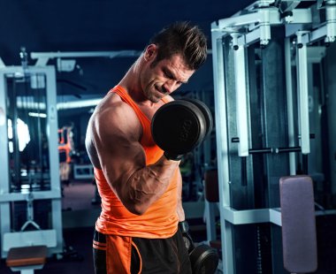 Kas koyu arka planda eğitim genç vücut geliştirmeci arkası