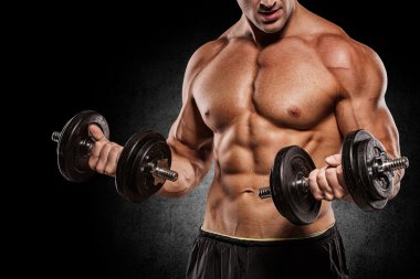 Kaslı vücut geliştirmeci adam egzersizleri izole dumbbells ile yapıyor