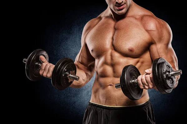 Muscular bodybuilder guy doing exercises with dumbbells isolated — Stock Photo, Image