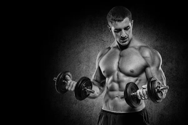 Muscular bodybuilder guy doing exercises with dumbbells isolated — Stock Photo, Image