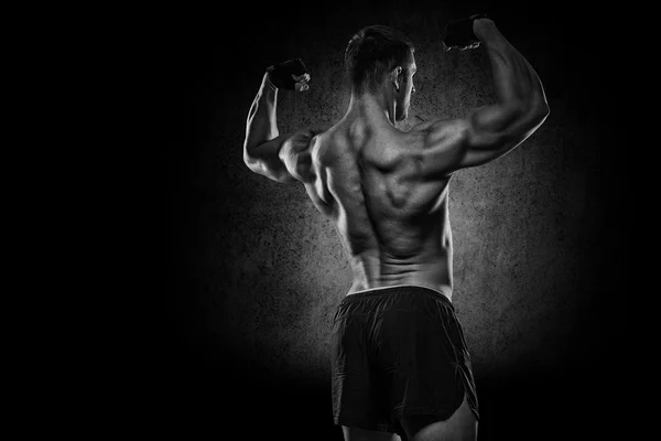 Bodybuilder showing his back and biceps muscles, personal fitnes — Stock Photo, Image