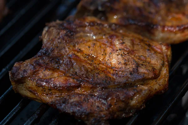 Gebakken varkensvlees biefstuk op de BBQ-barbecue close-up Rechtenvrije Stockafbeeldingen