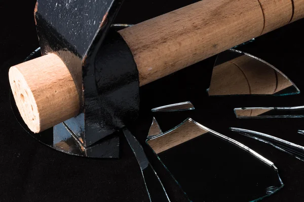 Hammer broken mirror pieces on a black background — Stock Photo, Image