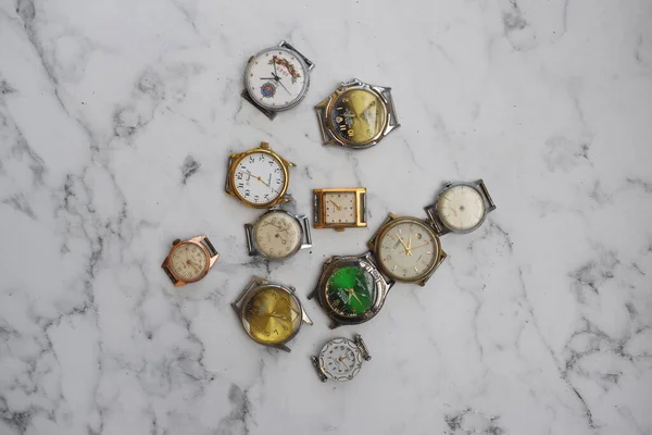 Viele alte Armbanduhren liegen auf dem Tisch, ohne Armband — Stockfoto