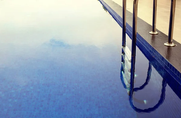 Grab Bar Scala Nella Piscina Blu Con Riflessi Soleggiati — Foto Stock