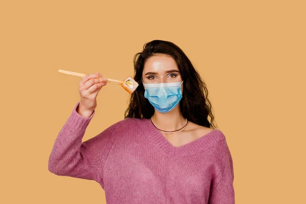 Girl Sushi Medical Mask Isolated Yellow Background Young Woman Holding — Stock Photo, Image