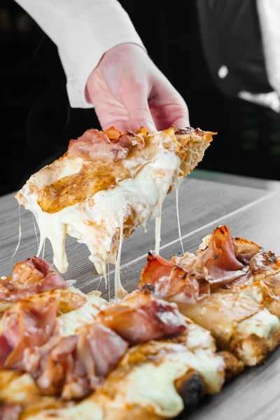 Mozzarella peynirini Pinsa romana gurmesi İtalyan mutfağına geriyor. Pizzacıdan yemek teslimatı. Abur cubur. Scrocchiarella, armut, peynir, ahşap kaplamalı jambon..