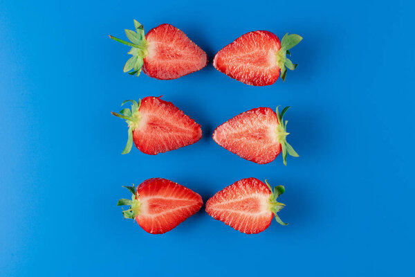 Sliced strawberry slices on blue background