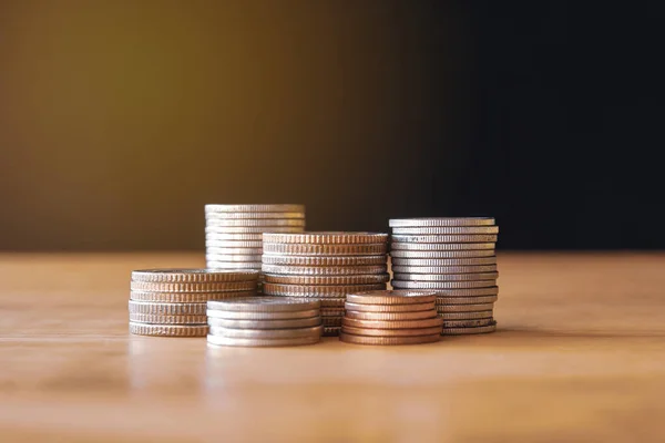 stack of coins and coin stacks on wooden table