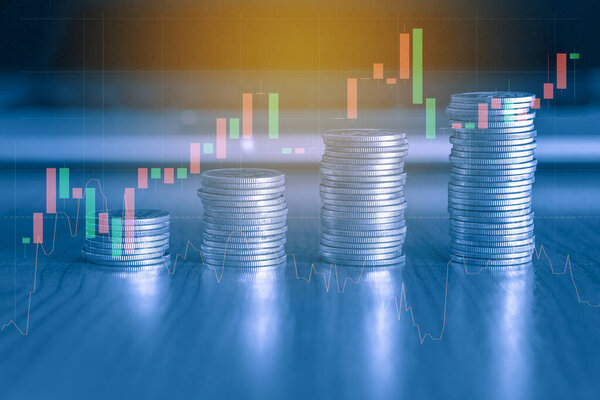 financial concept with coins and chart on the table