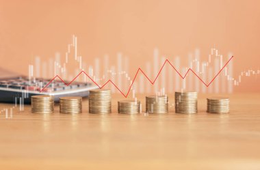 Coins stacked with calculator and graph