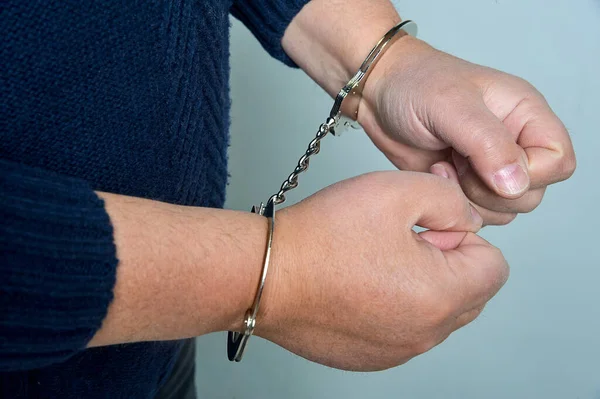Male hands cuffed in close-up — Stock Photo, Image