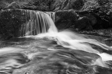 Hoar Oak Nehri 'nin üzerinde Exmoor Ulusal Parkı' ndaki Watersmeet 'te akan şelalenin uzun pozu.