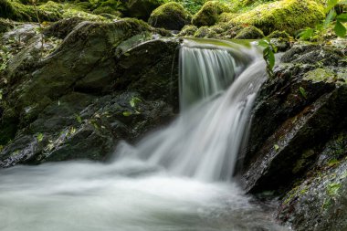 Hoar Oak Nehri 'nin üzerinde Exmoor Ulusal Parkı' ndaki Watersmeet 'te akan şelalenin uzun pozu.