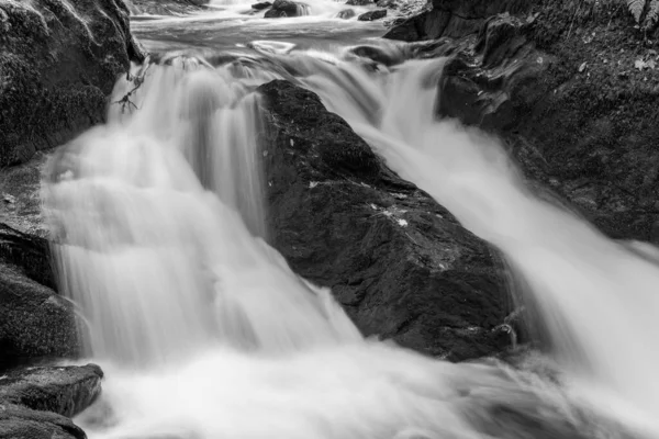 エキスモア国立公園のウォーターズミートの森を流れるイーストリン川の滝の長い露出 — ストック写真
