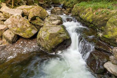 Doğu Lyn nehrinin üzerinde Exmoor Ulusal Parkı 'ndaki Watersmeet' te akan şelalenin uzun pozu