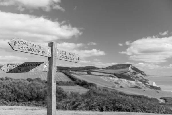 Close up of a footpath sign pointing to Golden Cap mountain on the Jurassic Coast in Dorset