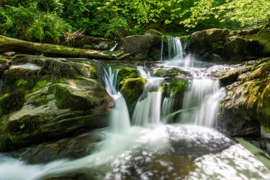 Long exposure of a waterfall on the Hoar Oak Water river at Watersmmeet in Exmoor National Park