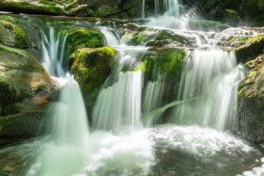 Long exposure of a waterfall on the Hoar Oak Water river at Watersmmeet in Exmoor National Park