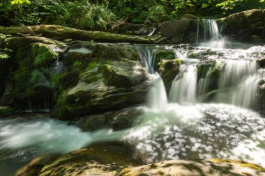 Long exposure of a waterfall on the Hoar Oak Water river at Watersmmeet in Exmoor National Park
