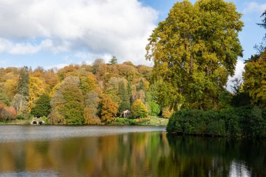Stourton. Wiltshire. Birleşik Krallık. 26 Ekim 2024. Wiltshire 'daki Stourhead Bahçeleri' ndeki gölün sonbahar renklerinin görüntüsü.