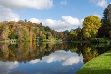 Stourton. Wiltshire. Birleşik Krallık. 26 Ekim 2024. Wiltshire 'daki Stourhead Bahçeleri' ndeki gölün sonbahar renklerinin görüntüsü.