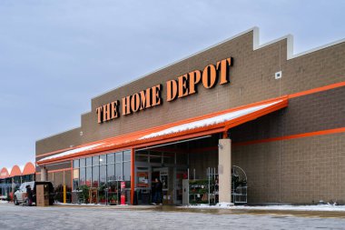 New Hartford, New York - 6 Aralık 2025: The Home Depot süpermarketinin kışın arka planda geniş bir görüntüsü, müşteriler yeni yıl alışverişini araçlarına yüklüyorlar
