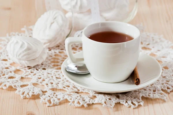 Cup of tea with cinnamon and marshmallows on the lace napkin — Stock Photo, Image