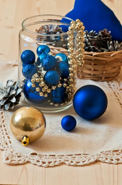 Blue and gold Christmas decorative balls in glass jar — Stock Photo, Image